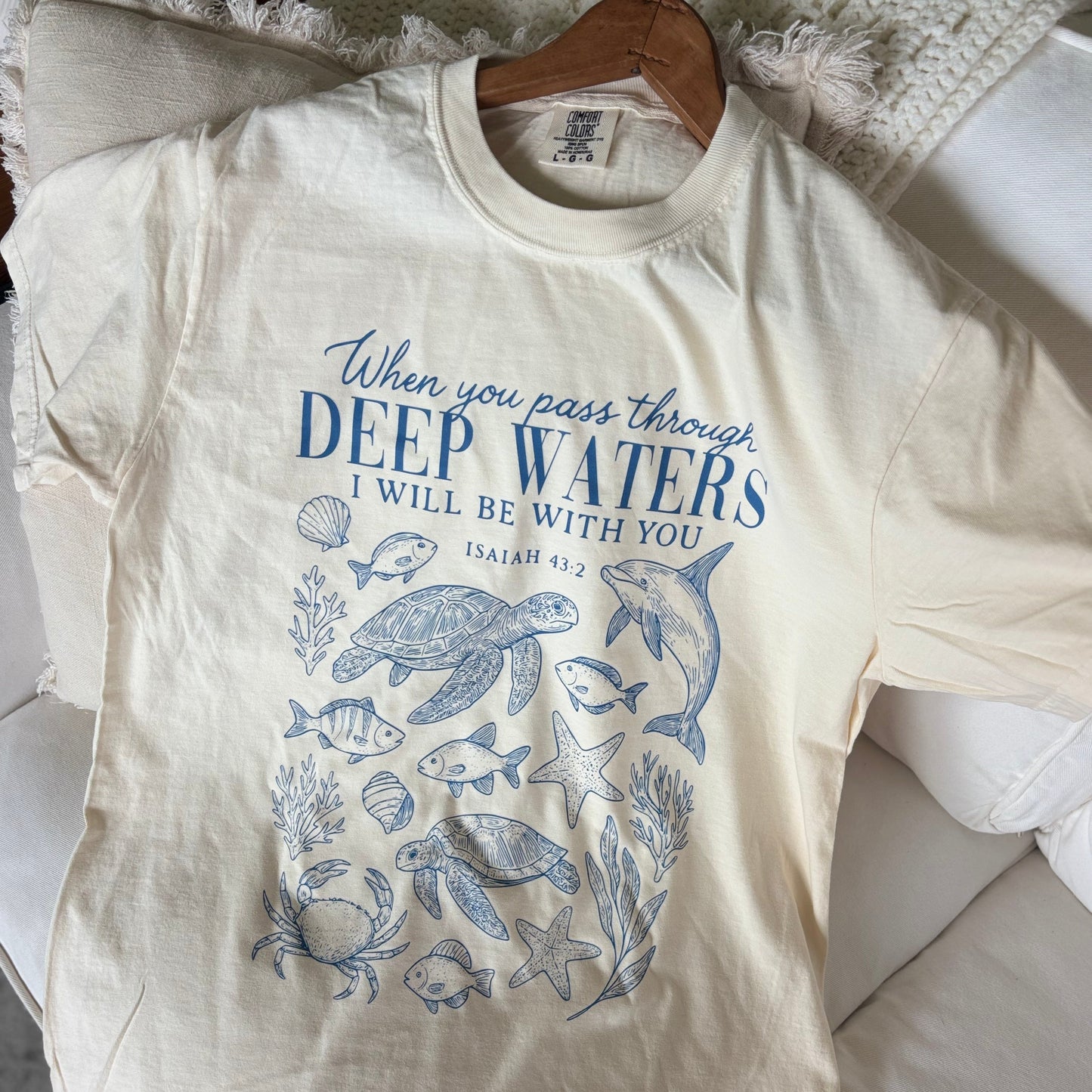 ocean-themed design on a cream shirt Isaiah 43:2 when you go through deep waters i will be with you