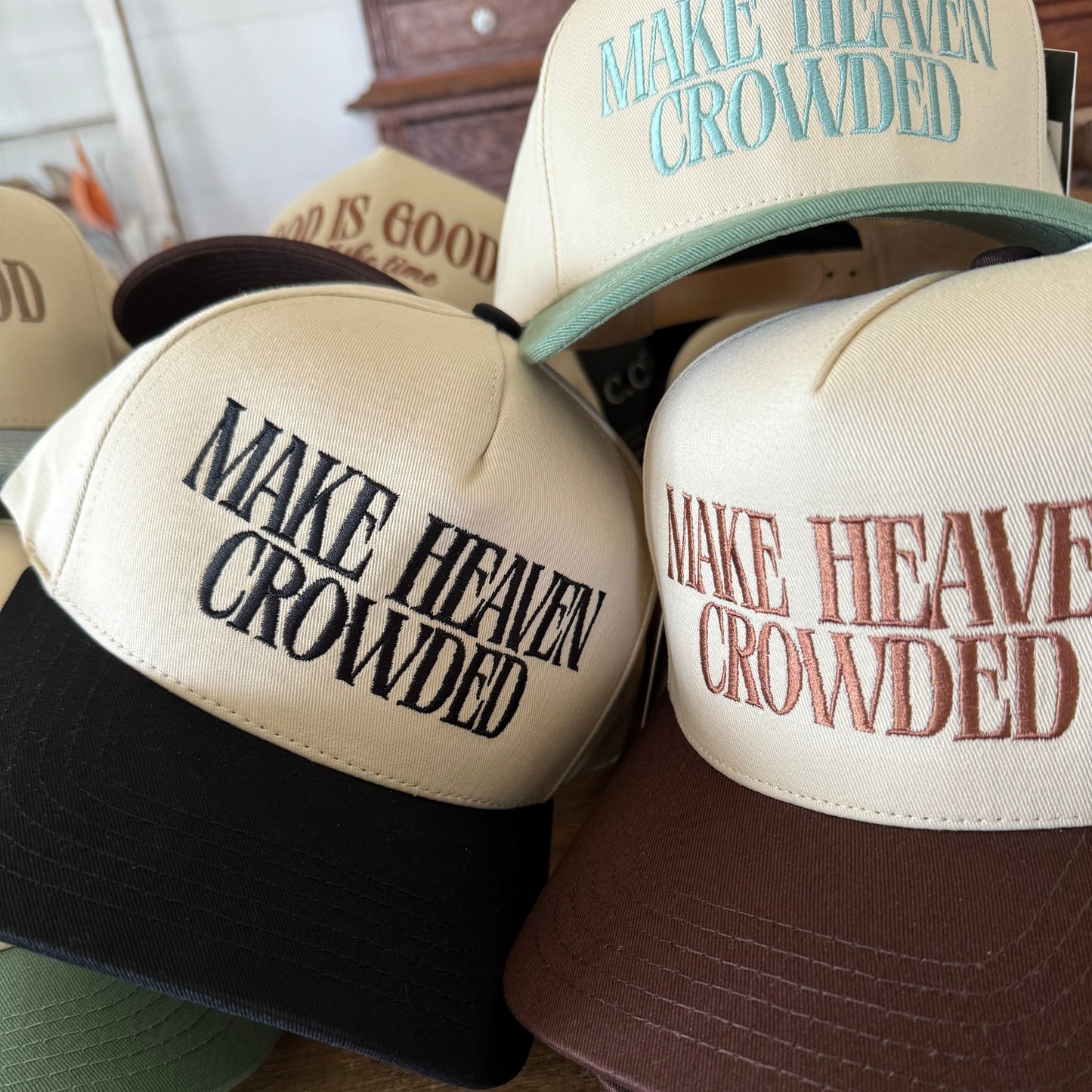 trucker baseball caps with the phrase make heaven crowded embroidered on it