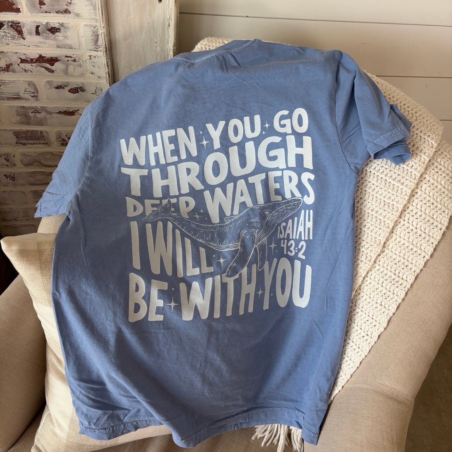A blue colored t-shirt with text 'WHEN YOU GO THROUGH DEEP WATERS I WILL BE WITH YOU' printed on both the front and back