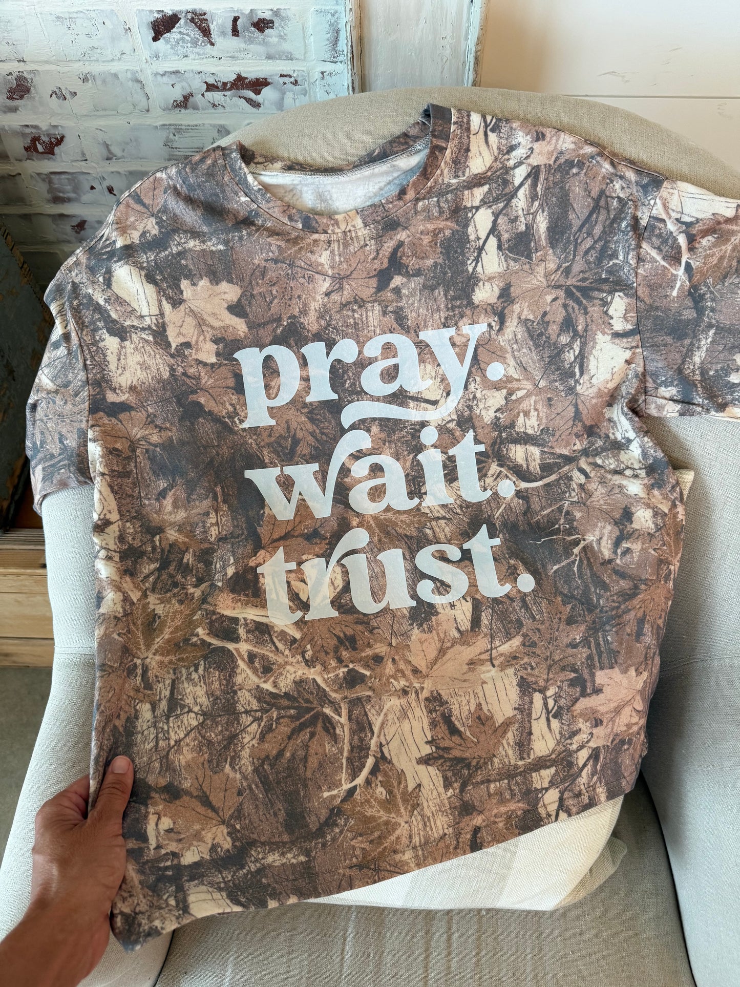 camo shirt with pray wait trust on it