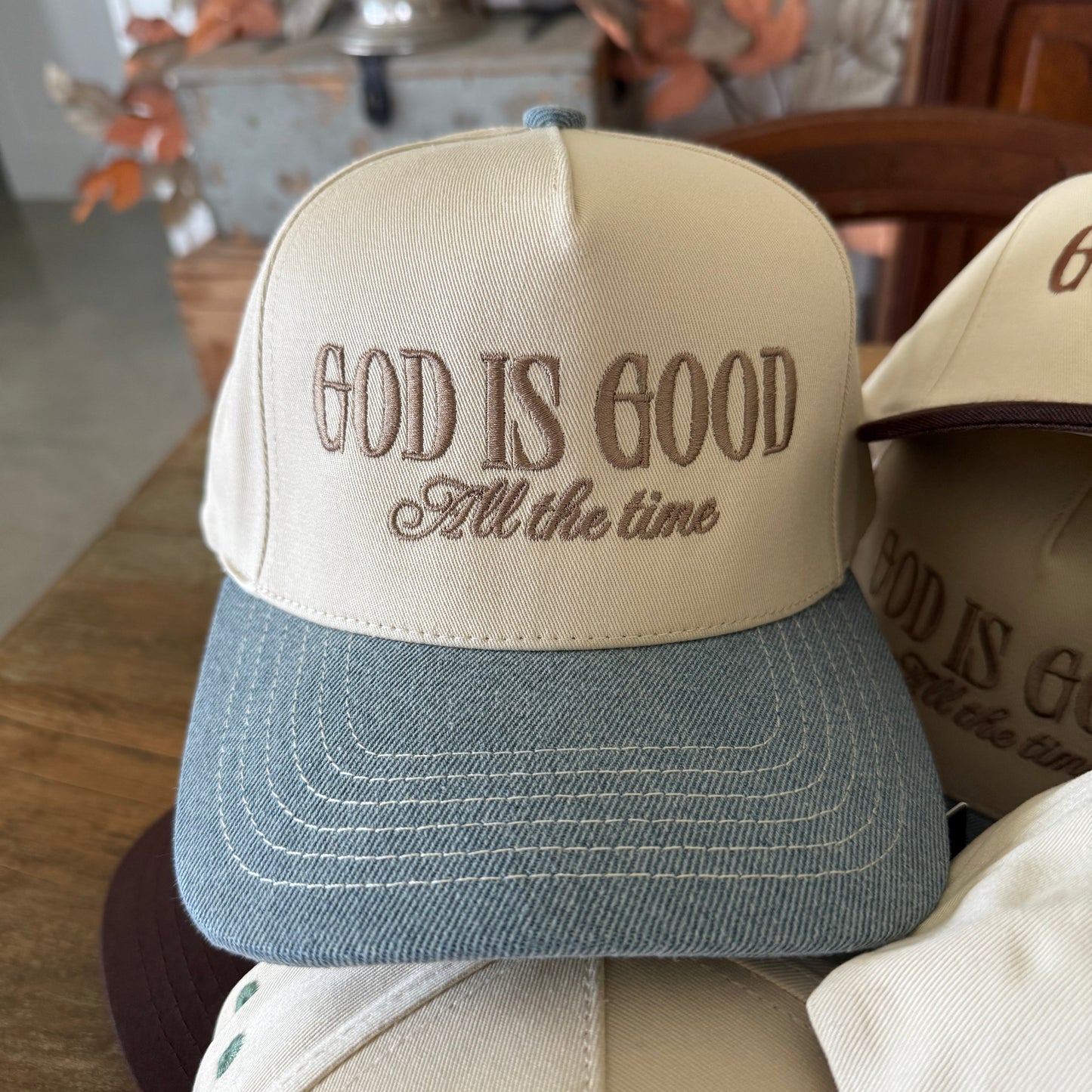 Collection of hats with 'God is Good All the Time'