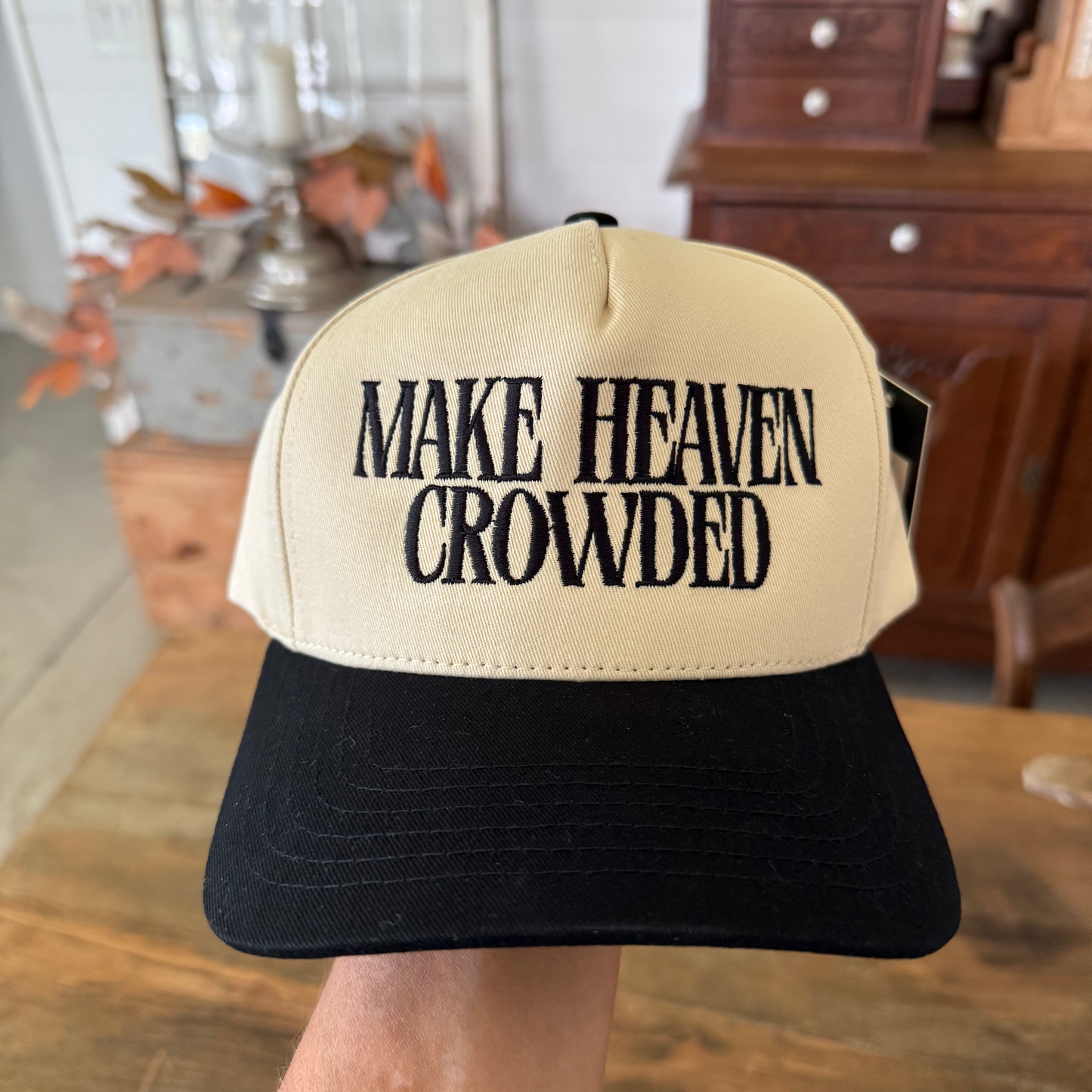Beige and black cap with 'MAKE HEAVEN CROWDED' text