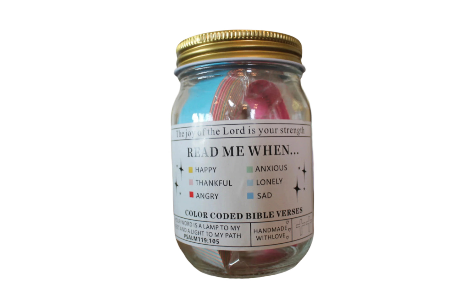 A glass jar with a gold lid, labeled 'Color Coded Bible Verse Jar' containing various colored paper or small cards with Bible verses.