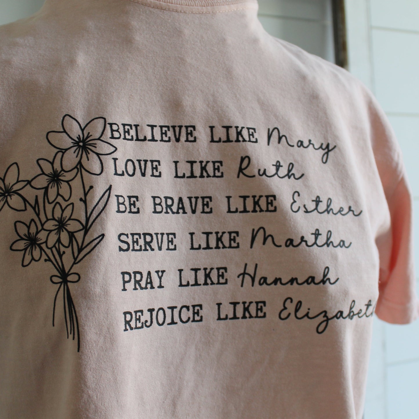 strong women of the bible on peach tee