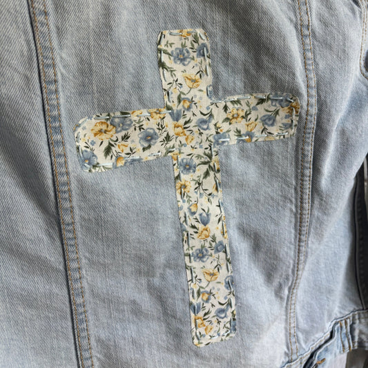 Floral cross patch on a denim jacket
