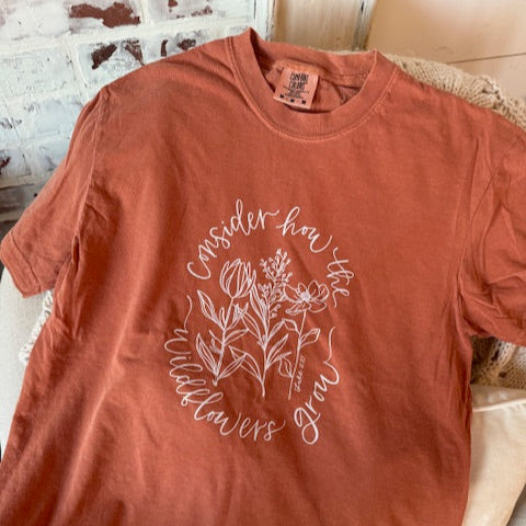 warm fall color shirt with scripture consider how the wildflowers grow